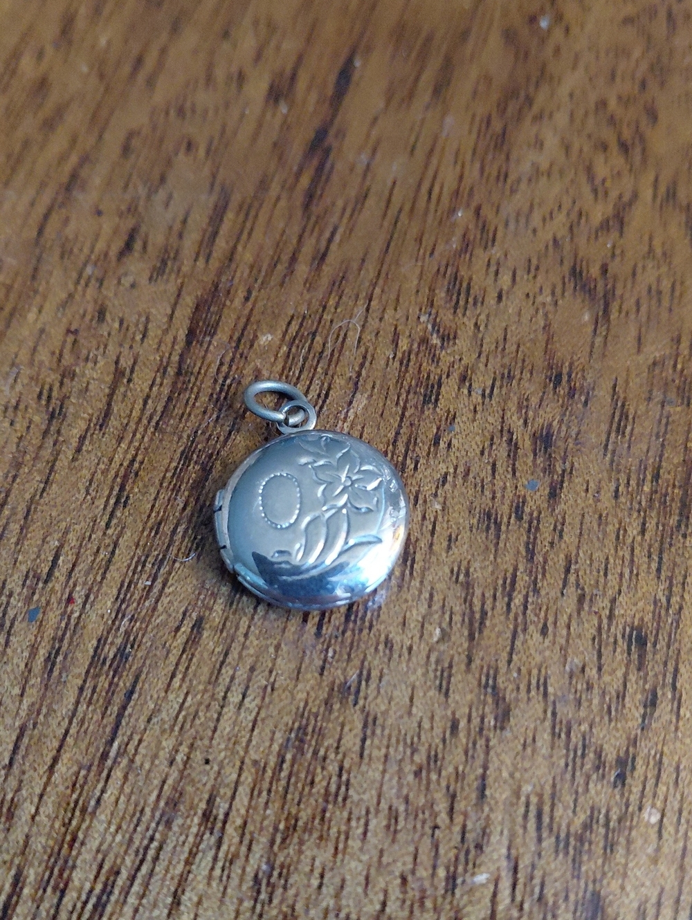 Dainty Locket Pendant In Stainless Steel Has A Monogram "O" On It